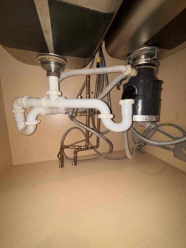 Conducted initial assessment of kitchen sink plumbing system and bathroom shower valve assembly. Created access point in ceiling/wall to inspect copper pipes and brass fittings. BASI scheduled to return tomorrow morning to complete necessary repairs, with both customer and BASI confirmed aware of the follow-up appointment.