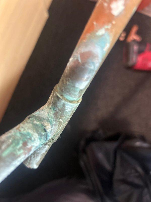 Responded to service call at rental property for faucet repair. Upon inspection, discovered severely corroded copper supply lines with significant verdigris formation and deterioration at connection points. Removed and replaced damaged copper T-fitting and associated piping to restore proper water flow and prevent potential leaks. All work was completed during morning appointment as requested.