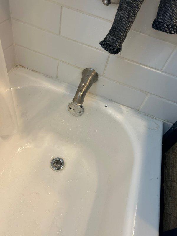 Responded to sold repair service (initially sold by Bryan C.) involving bathroom plumbing issues. Upon inspection, accessed ceiling area above bathroom to examine plumbing infrastructure, noting PVC connections with purple primer. Serviced bathtub/sink fixture and drain system, addressing water staining issues on the basin surface.