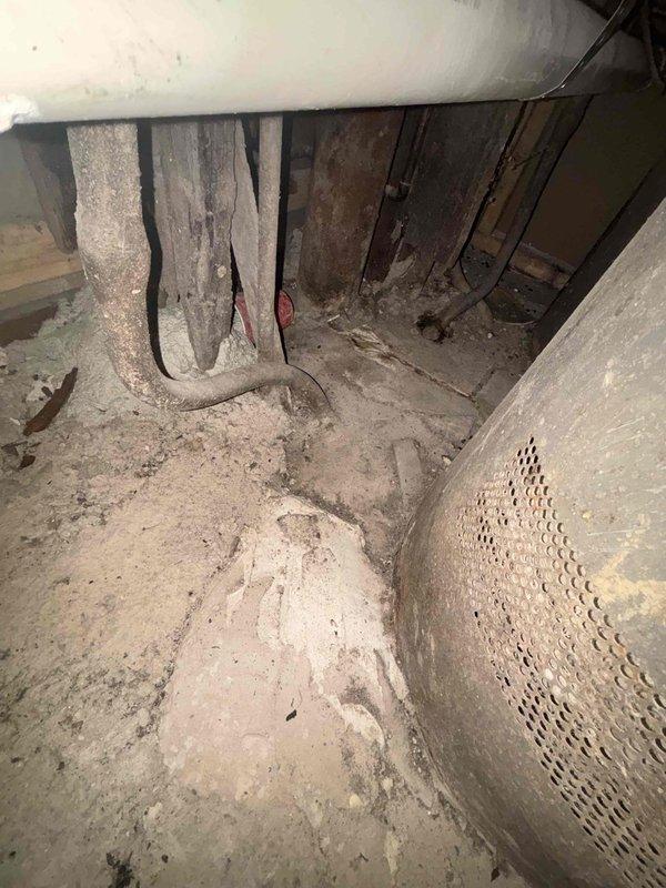 Conducted site assessment for lead service line replacement. Inspected access point in basement where excavation has exposed the existing pipe infrastructure. Noted significant moisture damage on surrounding walls and identified connection point where new service line would tie into existing PVC piping system.