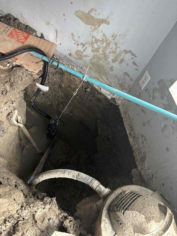Conducted site assessment for lead service line replacement. Inspected access point in basement where excavation has exposed the existing pipe infrastructure. Noted significant moisture damage on surrounding walls and identified connection point where new service line would tie into existing PVC piping system.