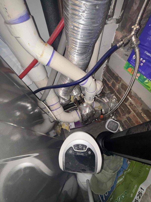 Relocated refrigerator water supply line from laundry room to position directly behind refrigerator installation location. Work involved rerouting PVC supply lines with appropriate fittings and connecting flexible water line to accommodate new appliance placement.