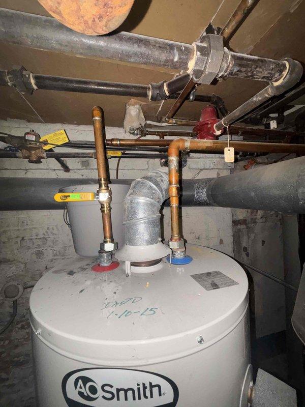 Performed comprehensive inspection of aging A.O. Smith water heater system installed January 2015. Evaluated copper supply lines, ventilation, and connection points for potential replacement as requested. Also assessed three toilets with slow flushing issues and examined customer-supplied showerhead for installation compatibility.