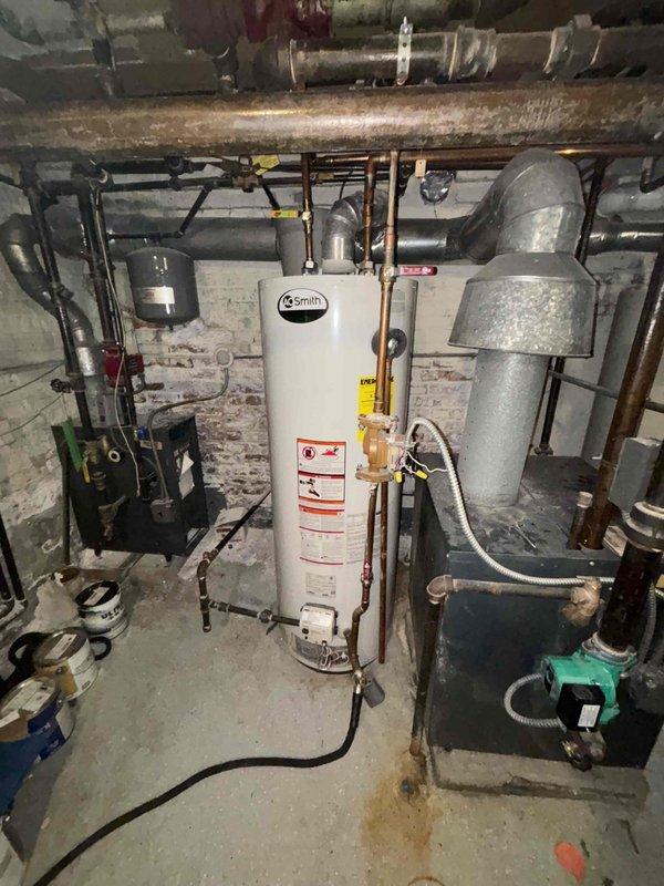 Performed comprehensive inspection of aging A.O. Smith water heater system installed January 2015. Evaluated copper supply lines, ventilation, and connection points for potential replacement as requested. Also assessed three toilets with slow flushing issues and examined customer-supplied showerhead for installation compatibility.