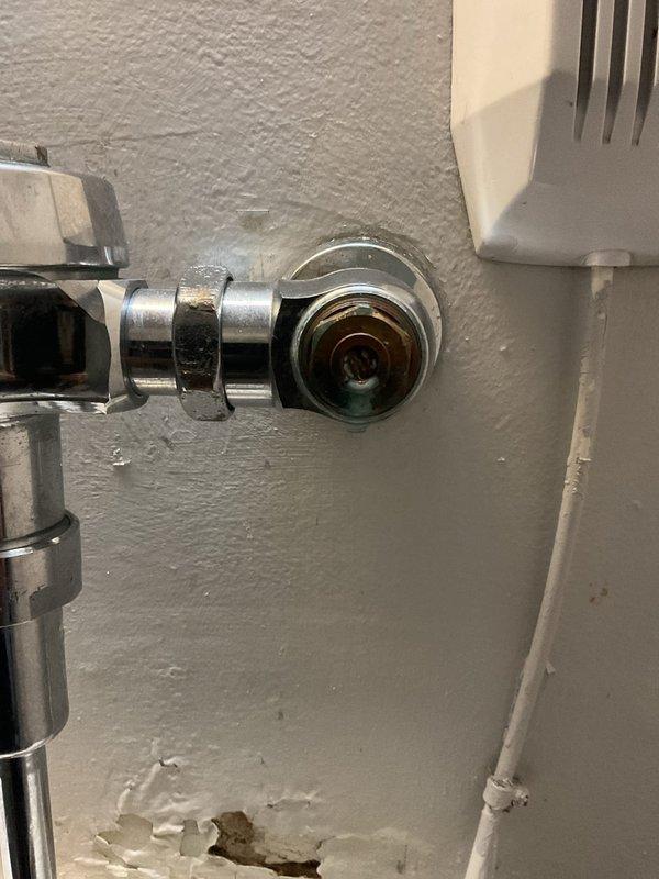 Successfully cleared clogged urinal in commercial restroom. Inspected chrome flush valve assembly and water supply connections, confirming proper operation after service. Noted minor wall damage near fixture base that may require future attention.