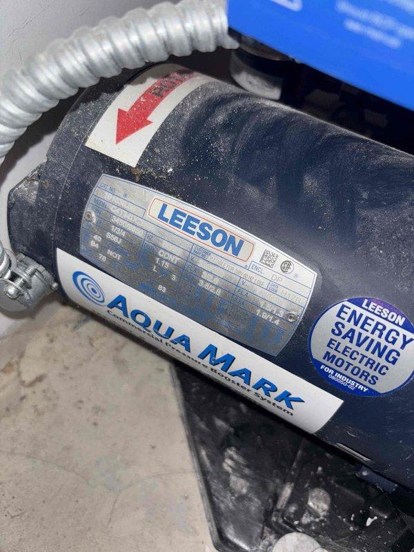 Responded to customer complaint of loud noise from Aqua Magic booster pump system. Inspected Leeson electric motor and found excessive vibration during operation. Tightened loose mounting bolts, replaced worn impeller, and cleaned debris from pump housing to eliminate noise. System now operating at normal noise levels with proper pressure maintained.