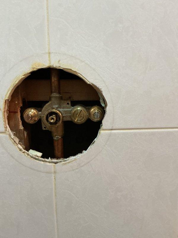Performed scheduled building water shutdown to execute previously approved repair work. Accessed concealed shower valve assembly by creating wall opening through existing tile. Successfully completed installation of new double basin stainless steel sink with pull-down faucet and secondary fixture in granite countertop as specified in the approved estimate.