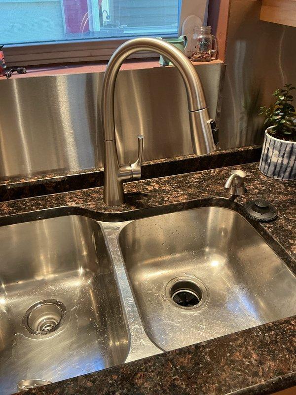 Performed scheduled building water shutdown to execute previously approved repair work. Accessed concealed shower valve assembly by creating wall opening through existing tile. Successfully completed installation of new double basin stainless steel sink with pull-down faucet and secondary fixture in granite countertop as specified in the approved estimate.