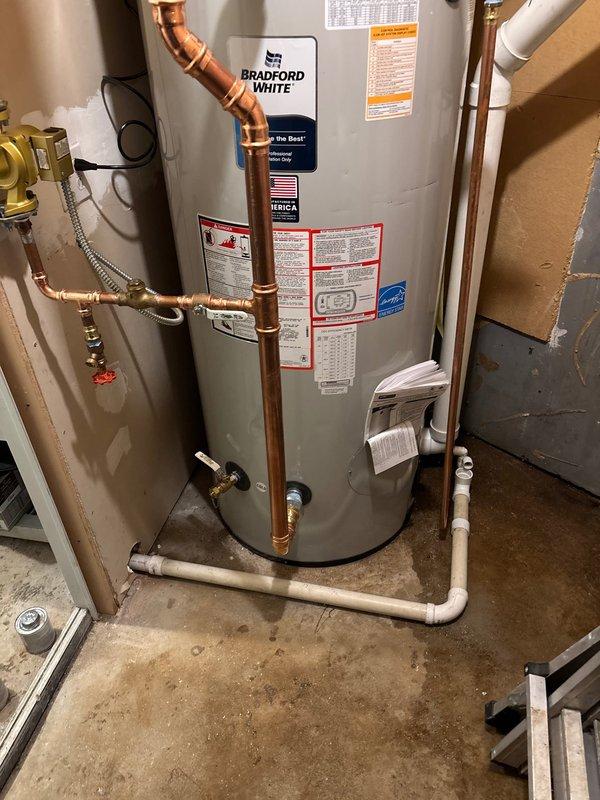 Inspected Bradford White water heater in utility area and examined exterior ventilation system. Job sold for future installation in spring 2026 as requested by customer. Documented current setup with photos for reference during scheduled installation.