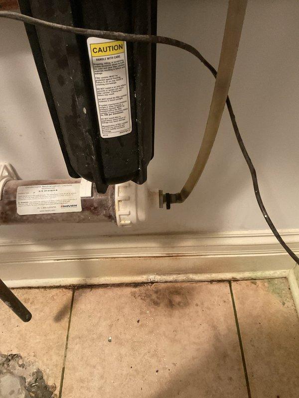 Completed warranty service by installing a new neutralizer unit and vinyl tubing on customer's HVAC/plumbing system. Replaced deteriorated components under the sink area and ensured proper drainage connections to address previous water damage issues. All work performed under lifetime workmanship warranty.