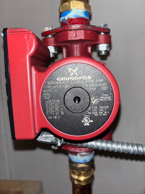 Replaced existing circulator pump with properly sized Grundfos UP15-42F non-submersible pump to address humming noise in baseboard heating system. Verified proper installation with correct flow direction as indicated by color-coded fittings. System is now operating efficiently with reduced noise, though customer was advised about pre-existing odor from one radiator that requires separate investigation.