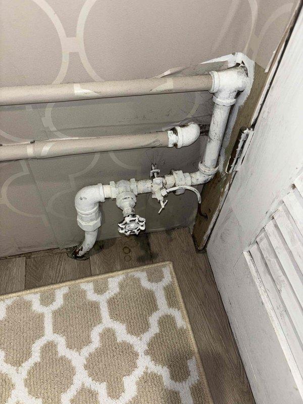 Responded to customer complaint of insufficient hot water during cold weather. Inspected tanked water heater installation in utility closet and examined associated plumbing connections. Determined temperature setting was inadequate for winter conditions and adjusted thermostat to compensate for colder incoming water temperature, restoring proper hot water supply.