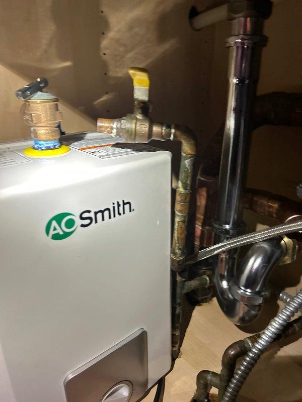 Completed water heater replacement with new AO Smith unit, installing all required copper piping and brass valves per code. Also addressed under-sink plumbing issues, replacing corroded copper supply lines and servicing the existing garbage disposal system to restore proper function.