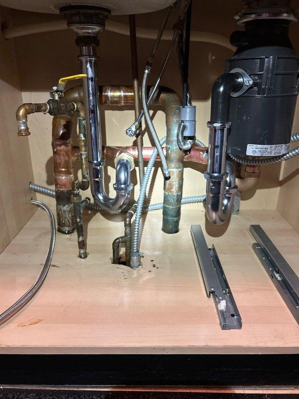 Completed water heater replacement with new AO Smith unit, installing all required copper piping and brass valves per code. Also addressed under-sink plumbing issues, replacing corroded copper supply lines and servicing the existing garbage disposal system to restore proper function.
