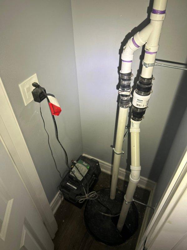 Responded to emergency call for water intrusion through walls. Upon inspection, identified a malfunctioning sump pump system with standing water in the collection basin. Discovered algae buildup and debris obstructing the drain grate. Cleared blockage, serviced the pump controller, and verified proper operation of the PVC drainage system with all valves and connection points intact.