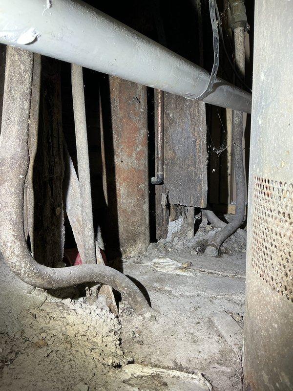 Conducted a callback service for Jon, inspecting basement access area with signs of water damage. Observed significant deterioration of wooden structural components in crawlspace and documented condition with photos. Identified potential moisture intrusion issues near exterior stairwell with wrought iron railings.