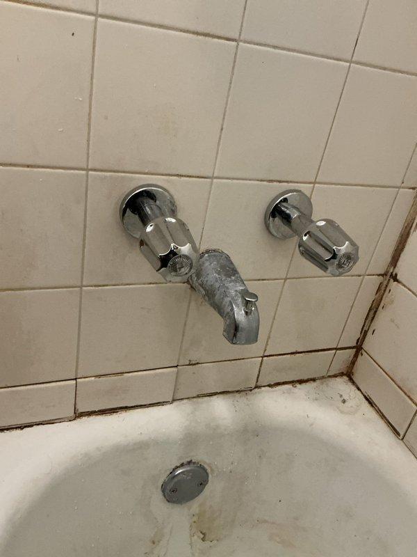 Responded to callback regarding lack of hot water following previous shower faucet repair. Inspection revealed extensive corrosion and mineral buildup on the tub faucet assembly with deteriorated central spout. Corroded components were affecting hot water flow. Replaced damaged cartridge and cleaned mineral deposits from valve body, restoring proper hot water function to the shower.