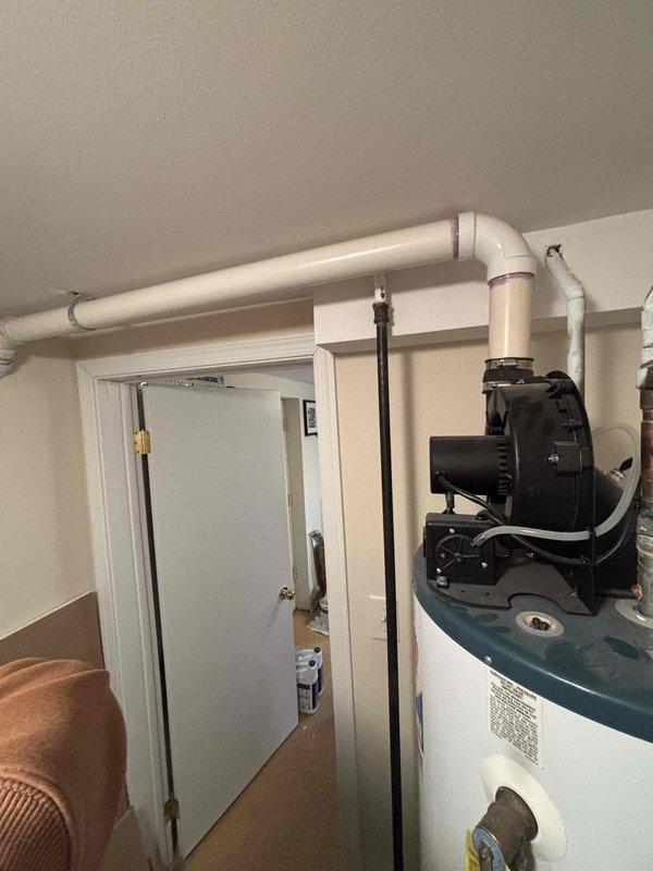 Inspected 17+ year old water heater that customer reported cycles on and off, requiring manual resets. Visual examination revealed significant corrosion at pipe joints, mineral buildup around connection points suggesting previous leakage, and an aging tank system. Recommended replacement due to unit age and intermittent operation issues.