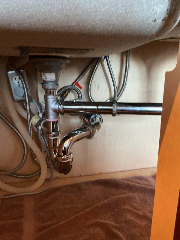 Responded to service call regarding a leaking P-trap under kitchen sink. Upon inspection, identified the source of leakage in the chrome P-trap assembly. Removed existing P-trap components, installed new P-trap with proper seals, and verified all connections were secure. Tested drain system for proper function and confirmed no further leaks present.