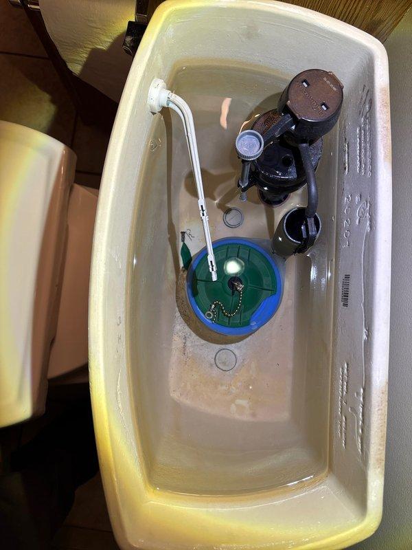 Diagnosed and repaired a running toilet issue by replacing the faulty flush valve assembly that was preventing proper chain latching. Removed tank lid, inspected internal components, and installed new flush valve mechanism to restore proper flushing function and eliminate continuous water flow.