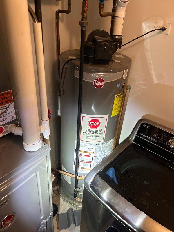 Inspected 50-gallon Rheem Performance water heater (5.5 years old) that was leaking from the base. Documented existing installation setup including expansion tank, pump unit, copper supply lines, and PVC venting system. Recommended replacement due to tank failure.