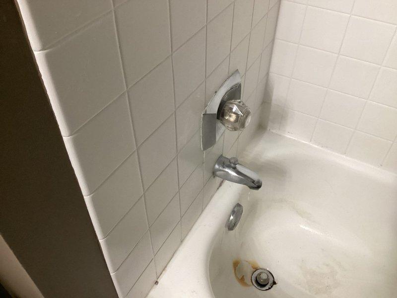 Conducted comprehensive plumbing estimate for multiple fixtures in high-rise condominium unit. Inspection revealed bathtub with visible drain discoloration and aging chrome fixtures, plus under-sink P-trap assembly showing signs of wear with potential water damage to surrounding cabinetry. Recommended replacement of bathtub drain assembly, faucet repair, P-trap replacement, and verification of dishwasher and laundry connections.