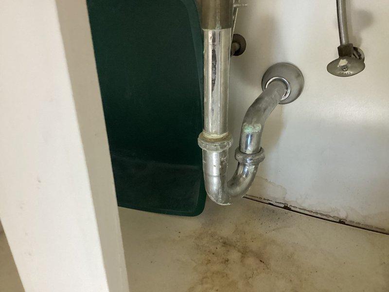 Conducted comprehensive plumbing estimate for multiple fixtures in high-rise condominium unit. Inspection revealed bathtub with visible drain discoloration and aging chrome fixtures, plus under-sink P-trap assembly showing signs of wear with potential water damage to surrounding cabinetry. Recommended replacement of bathtub drain assembly, faucet repair, P-trap replacement, and verification of dishwasher and laundry connections.