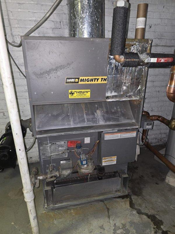 Performed callback inspection of Mighty Therm heating system installation in basement. Verified proper connections of copper supply lines, PVC venting, and checked operation of circulation pump. Noted minor moisture on concrete floor beneath unit; confirmed not due to active leaks but residual condensation. System functioning within normal parameters.
