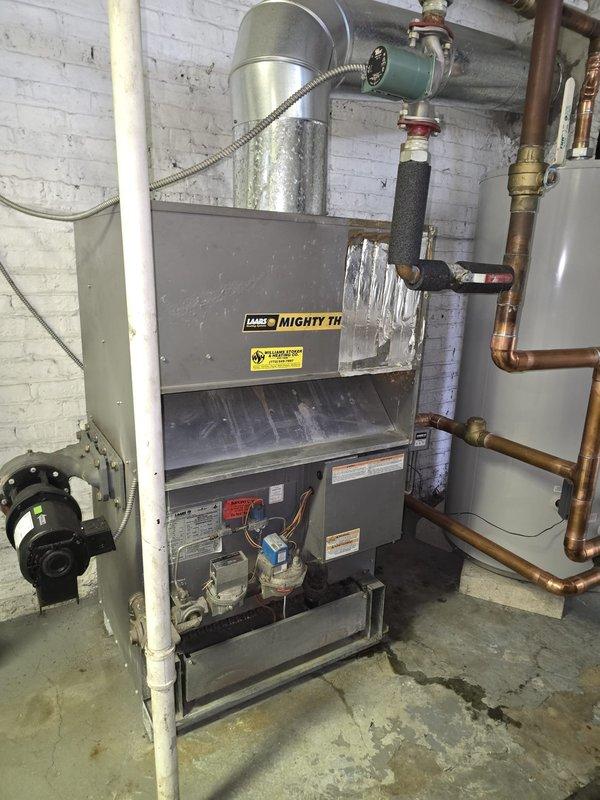 Performed callback inspection of Mighty Therm heating system installation in basement. Verified proper connections of copper supply lines, PVC venting, and checked operation of circulation pump. Noted minor moisture on concrete floor beneath unit; confirmed not due to active leaks but residual condensation. System functioning within normal parameters.