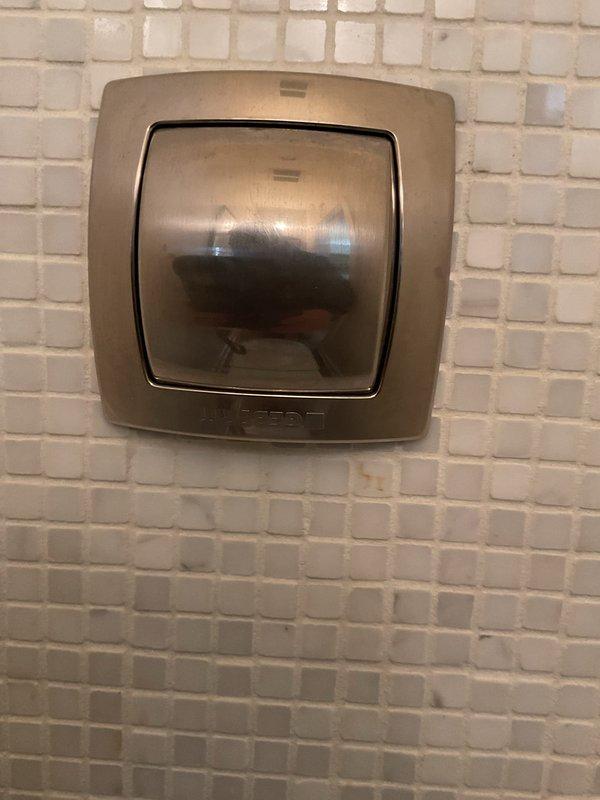 Responded to service call for malfunctioning Geberit wall-mounted toilet flushing mechanism. Accessed recessed wall panel to inspect water supply lines, valves, and pressure switch components. Diagnosed issues with the flush activation system requiring specialized technician intervention.