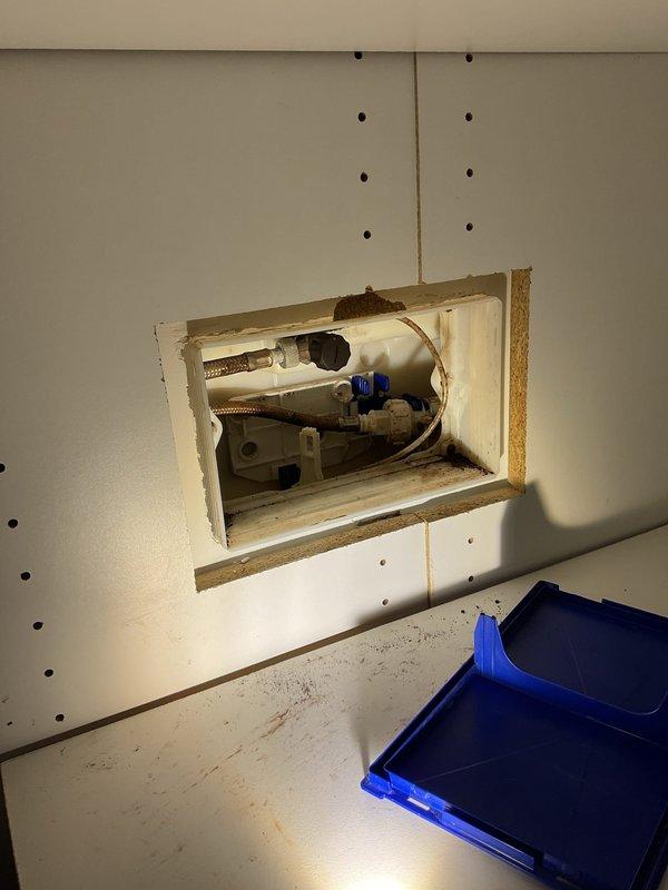 Responded to service call for malfunctioning Geberit wall-mounted toilet flushing mechanism. Accessed recessed wall panel to inspect water supply lines, valves, and pressure switch components. Diagnosed issues with the flush activation system requiring specialized technician intervention.