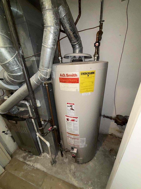Conducted estimate for replacement of existing A.O. Smith EnergySaver water heater that is not producing sufficient hot water. Inspection revealed aging tank with standard copper pipe connections and brass valves. Recommended full tank replacement to restore proper hot water temperature and efficiency.