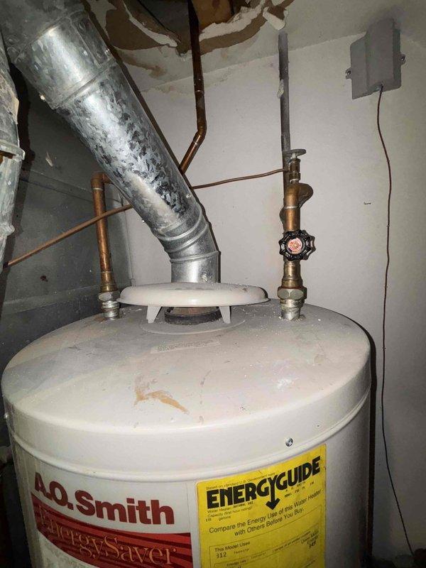 Conducted estimate for replacement of existing A.O. Smith EnergySaver water heater that is not producing sufficient hot water. Inspection revealed aging tank with standard copper pipe connections and brass valves. Recommended full tank replacement to restore proper hot water temperature and efficiency.