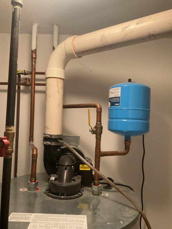 Conducted on-site inspection of 12-14 year old water heater (estimated 75-100 gallons) that was not producing adequate hot water. Evaluated existing plumbing infrastructure including copper supply lines, PVC drainage system, expansion tank, and associated valves. Also assessed drain system for reported drain fly infestation, which likely requires cleaning service to resolve.