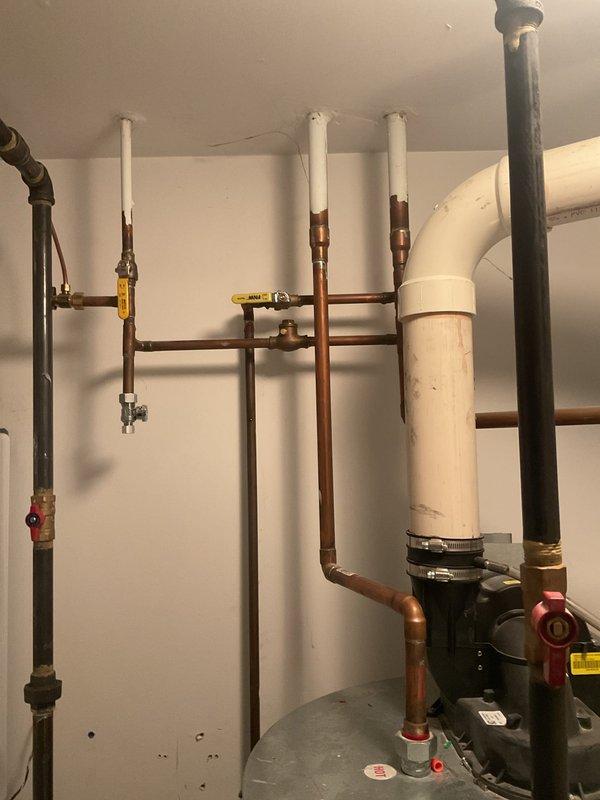 Conducted on-site inspection of 12-14 year old water heater (estimated 75-100 gallons) that was not producing adequate hot water. Evaluated existing plumbing infrastructure including copper supply lines, PVC drainage system, expansion tank, and associated valves. Also assessed drain system for reported drain fly infestation, which likely requires cleaning service to resolve.