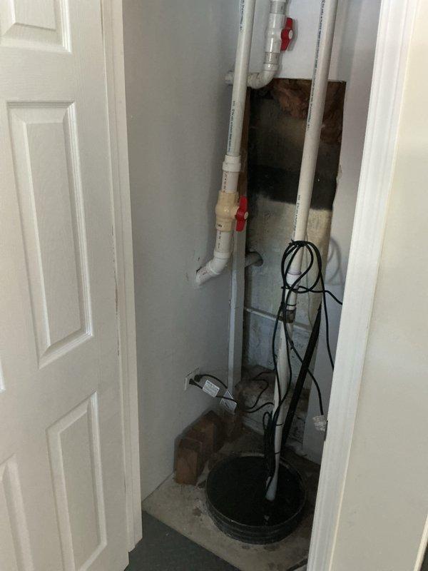 Conducted comprehensive camera inspection of plumbing system, focusing on utility access points with brass shut-off valves and PVC piping with red valve handles. Inspected sump pump basin and associated drainage components for proper functionality. Identified areas with discoloration and potential corrosion requiring attention.