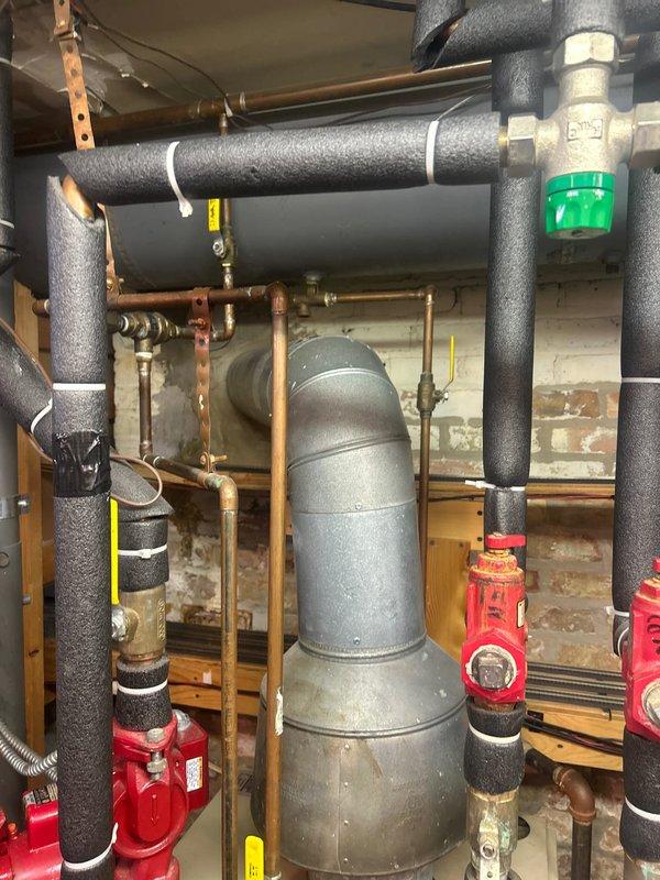 Responded to emergency service call for leaking temperature-pressure relief valve on tanked water heater. Inspected the mechanical room plumbing system, which showed water discharge from the T&P valve and evidence of leakage affecting the nearby furnace. Replaced the faulty relief valve, tested system pressure, and verified proper operation of the replacement component with no further leakage.