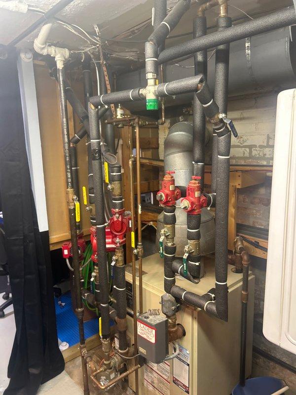 Responded to emergency service call for leaking temperature-pressure relief valve on tanked water heater. Inspected the mechanical room plumbing system, which showed water discharge from the T&P valve and evidence of leakage affecting the nearby furnace. Replaced the faulty relief valve, tested system pressure, and verified proper operation of the replacement component with no further leakage.