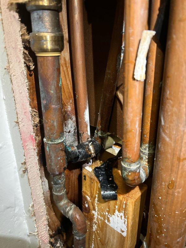 Responded to emergency call for burst pipe under kitchen sink. Upon inspection, discovered copper supply line with corrosion damage causing leak within cabinet space. Replaced damaged section of copper pipe with appropriate fittings, tested system for proper water pressure and absence of leaks, and verified cabinet interior sustained minimal water damage with no structural compromise to surrounding cabinetry.