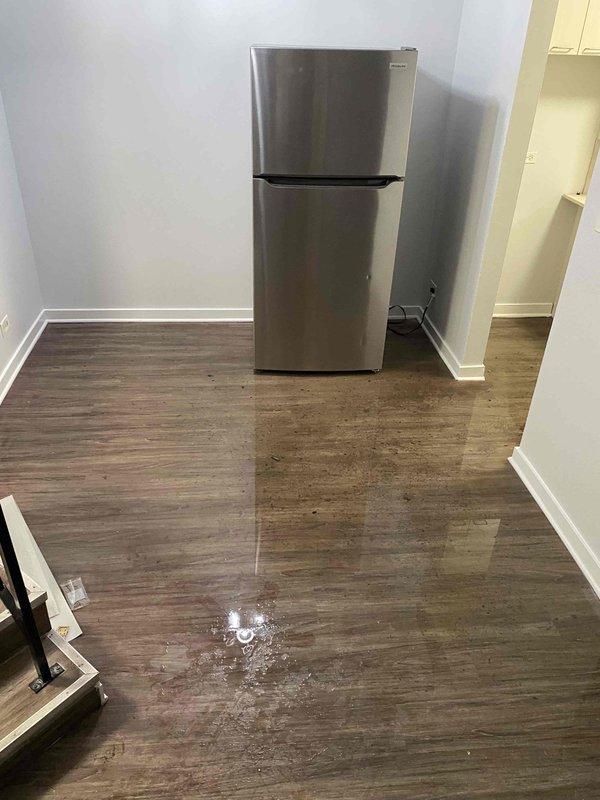 Responded to service call for backed up kitchen sink. Upon arrival, observed significant water leakage and spillage on the kitchen floor with visible puddles near the refrigerator and under the sink cabinet. Cleared the clogged drain line using appropriate drain cleaning equipment and verified proper drainage function. Advised customer on preventative maintenance practices to avoid future blockages.