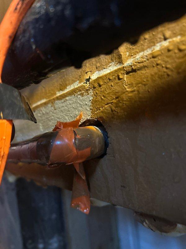 Conducted initial assessment of deteriorated plumbing system, identifying oxidized copper pipes with failing tape repairs and evidence of moisture damage to surrounding wall structures. Scheduled immediate follow-up service with additional technician for comprehensive pipe replacement and wall repair to address visible water damage and potential leakage points.