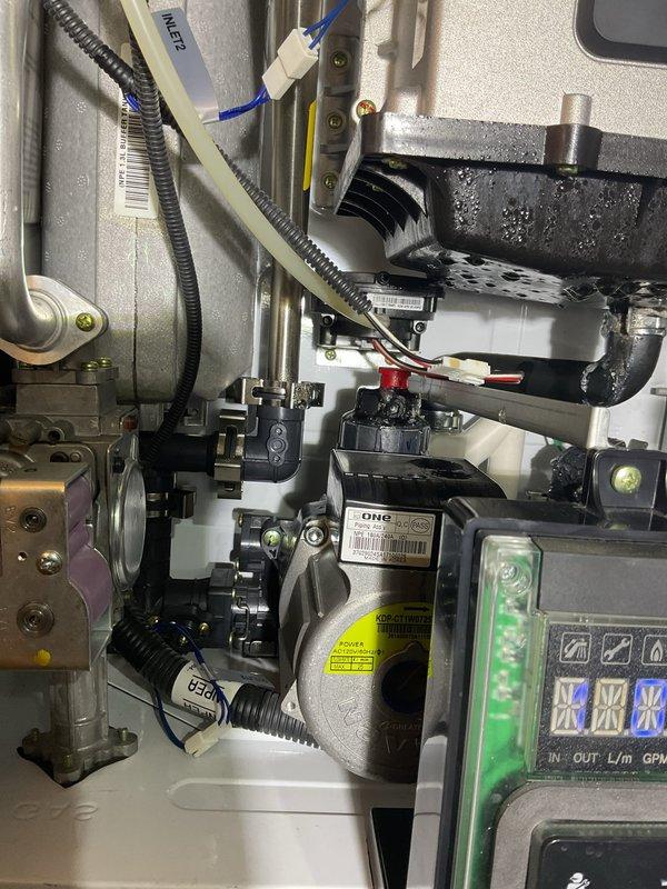 Responded to VIP customer complaint regarding Navien tankless water heater leaking from the bottom. Upon inspection, identified mineral buildup and scaling on heat exchanger components causing condensate leakage. Cleaned affected areas, checked all connections and valves for proper operation, and confirmed system was functioning correctly with normal flow readings on digital display before departure.