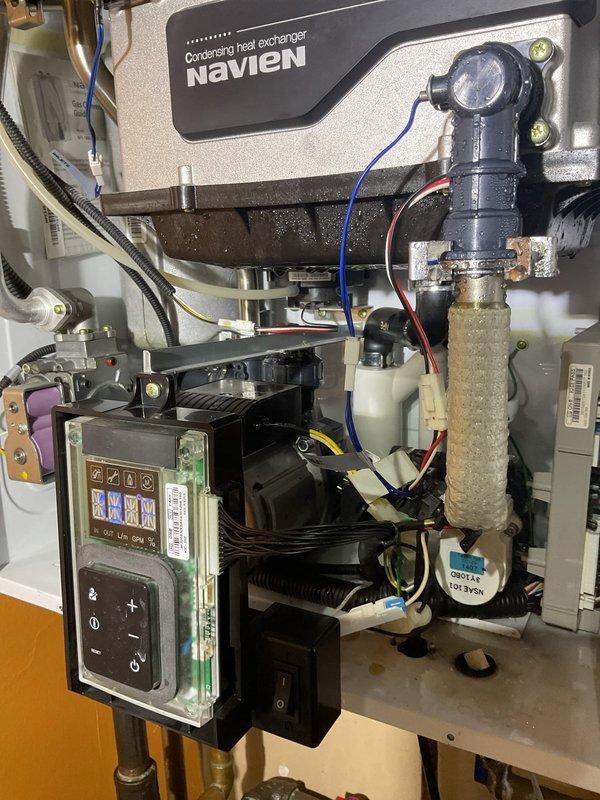 Responded to VIP customer complaint regarding Navien tankless water heater leaking from the bottom. Upon inspection, identified mineral buildup and scaling on heat exchanger components causing condensate leakage. Cleaned affected areas, checked all connections and valves for proper operation, and confirmed system was functioning correctly with normal flow readings on digital display before departure.