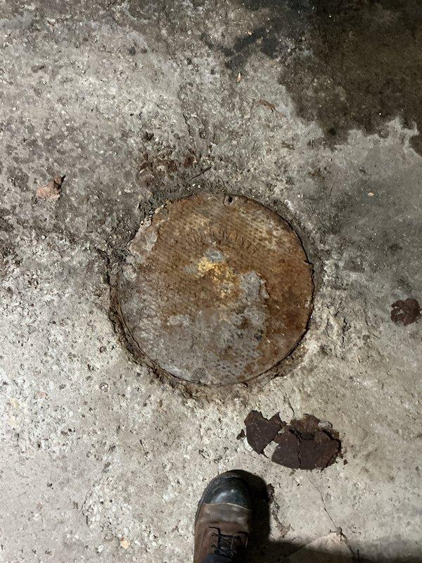 Responded to customer complaint regarding odor from grease trap. Inspection revealed severely corroded access cap with significant rust deterioration around the circumference. Opened and cleaned grease trap, removing accumulated debris and buildup that was causing the reported smell. Recommended future maintenance schedule to prevent recurrence.