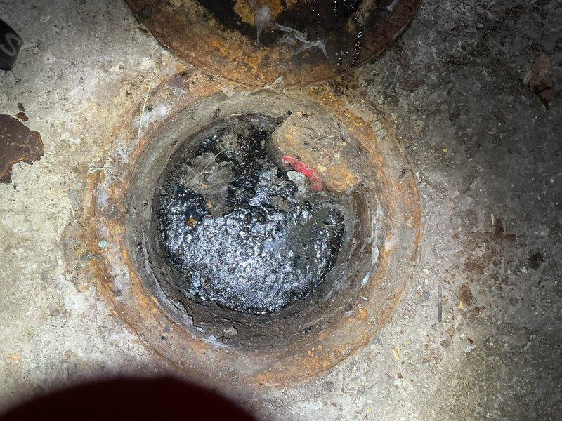Responded to customer complaint regarding odor from grease trap. Inspection revealed severely corroded access cap with significant rust deterioration around the circumference. Opened and cleaned grease trap, removing accumulated debris and buildup that was causing the reported smell. Recommended future maintenance schedule to prevent recurrence.