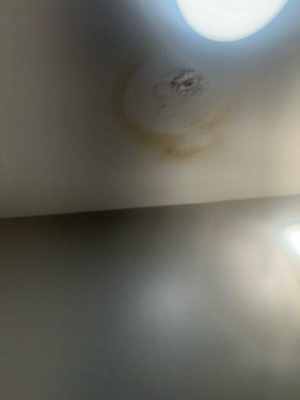 Conducted leak investigation for ceiling water damage in first floor bathroom. Visual inspection revealed significant water staining and discoloration on ceiling. Toilet in upstairs bathroom identified as source of leak due to faulty wax ring seal. Replaced wax ring and secured toilet properly to prevent further water seepage.