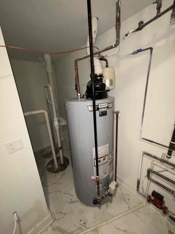 Conducted inspection of existing sump pump system and provided estimate for installation of battery backup system. Observed current drainage setup including floor drains and PVC discharge plumbing. Evaluated water heater proximity and existing utility connections to determine optimal battery backup placement and integration requirements.