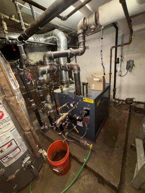 Conducted comprehensive leak investigation in multi-unit building experiencing high water bills and low pressure complaints. Inspected boiler system and surrounding plumbing infrastructure in mechanical room, examining extensive network of galvanized and copper piping for signs of leakage. Identified minor corrosion at several pipe joints requiring preventative maintenance to avoid future water loss.