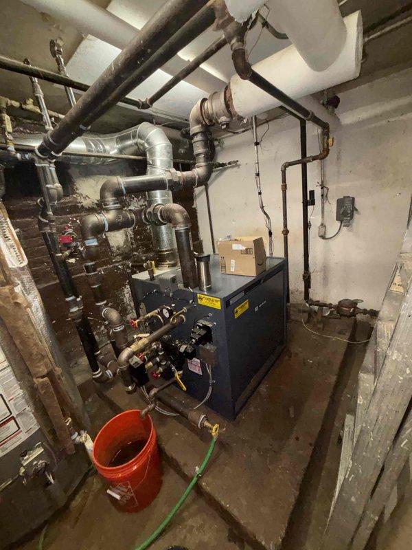 Conducted comprehensive leak investigation in multi-unit building experiencing high water bills and low pressure complaints. Inspected boiler system and surrounding plumbing infrastructure in mechanical room, examining extensive network of galvanized and copper piping for signs of leakage. Identified minor corrosion at several pipe joints requiring preventative maintenance to avoid future water loss.