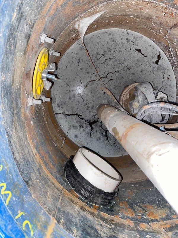 Collected down payment for repair job sold by Jon H. Cut access hole in basement concrete floor to expose damaged drain pipe. Documented existing plumbing infrastructure and significant cracking in concrete drain cap/floor with evidence of water infiltration requiring repair.